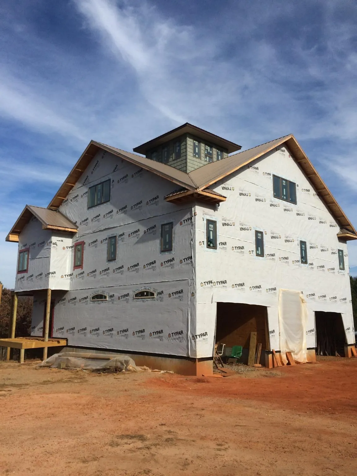 New two story house under construction with a cupola and gabled roofs in Buford